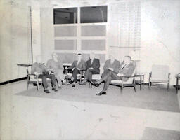 NMC Alumni Basketball 1960-61: Six Men Sitting in Chairs