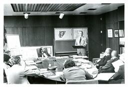 John X. Jamrich and Group Listening to Speaker (Part of the NMU Historic Photographs Collection)