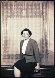 (168-007) Portrait of a middle-aged woman in a skirt and blouse