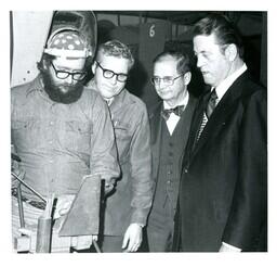 John X. Jamrich and Two Other Men Watching a Welder (Part of the NMU Historic Photographs Collection)