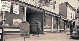 (004-015) Man Standing in front of Lakeside Garage