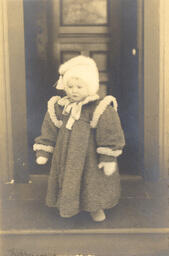 Child with coat and hat