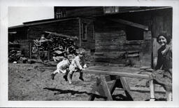 Young Tom Ross Balancing on Sawhorse