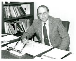 Dean Little Sitting at Desk (Part of the NMU Historic Photographs Collection)