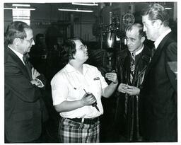 Student Talking to John X. Jamrich and Two Other Men in Shop (Part of the NMU Historic Photographs Collection)