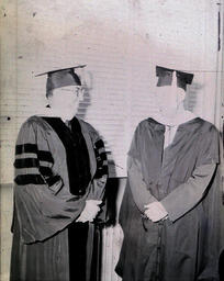 (512-01) Commencement--Dr. Harden and Gunther Meyland Jan. 1961: Two Men in Graduation Gowns Looking at Each Other