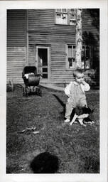 Baby Standing over Dog