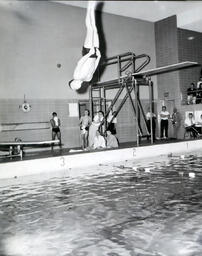 NMC Swimming--NMC vs. Green Bay--YMCA Feb. 25, 1961: Man Diving into Pool