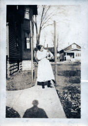 Woman Holding Cat on Sidewalk