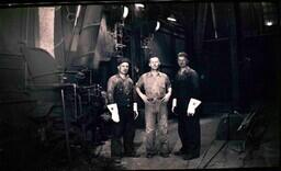 (010-010) Three Men Posing Next to Equipment