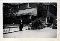 Dorotha (Davidson) Ross in front of Brick House