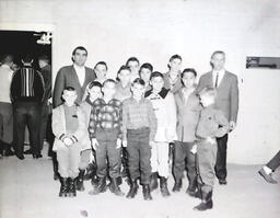 NMC Varsity N Club and Boys from Holy Family Orphanage Feb. 24, 1961: Group of Boys and Men Posing for Group Photo