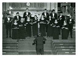 Choir Singing in Matching Formal Wear in front of Church Altar (Part of the NMU Historic Photographs Collection)