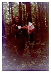 Competitor Posing with Flag in the Woods (Part of the NMU Historic Photographs Collection)