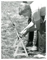 Man Checking Fuses on Nezzy Rocket (Part of the NMU Historic Photographs Collection)