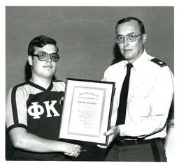 Fraternity Member Receiving Merit Award from Man in Military Uniform (Part of the NMU Historic Photographs Collection)