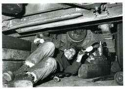 Man Working under a Car (Part of the NMU Historic Photographs Collection)