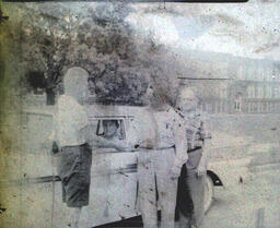 Driver Education 1959: Blurry Photo of Man in Car With Multiple People Standing Next to Window