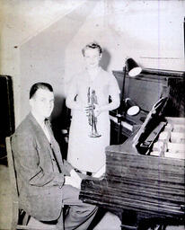 (151-01) NMC Band Concert May 25, 1960: Woman Holding Trumpet, Man at Piano