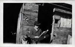 Young Tom Ross and Father Reading the Paper