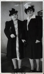 Two Women in Dark Coats and Hats