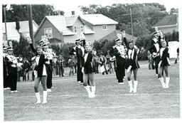 Marching Band Performing on Football Field in front of Residential Neighborhood (Part of the NMU Historic Photographs Collection)