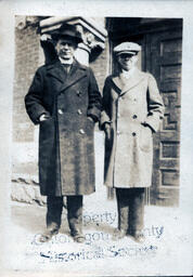 Man and Boy in Overcoats and Hats