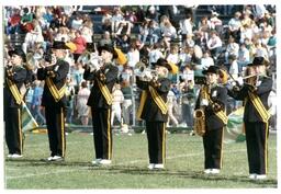 Line of Marching Band Students Performing at Football Game (Part of the NMU Historic Photographs Collection)