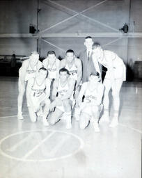 NMC Basketball--Jerry Wright;Bob Armstead;Group Picture 1960-61: Seven Men in Basketball Uniforms with Man in Suit