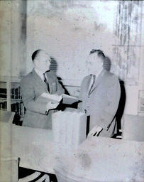 (627-02) Library Presentation--L.W. Jenner, President; Cliffs Down C.C.; Norman J. Bunker NMC Librarian Apr. 5, 1961