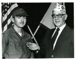 Medal Being Pinned onto ROTC Student by Man Wearing Amvets Cap (Part of the NMU Historic Photographs Collection)