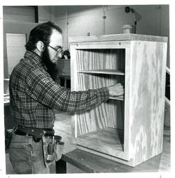 Man Working on Cabinet in Woodshop (Part of the NMU Historic Photographs Collection)