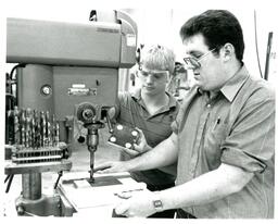 Two Students Using Drill Press with Jig (Part of the NMU Historic Photographs Collection)