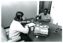 Two Men Doing Activity Next to Recording Equipment (Part of the NMU Historic Photographs Collection)