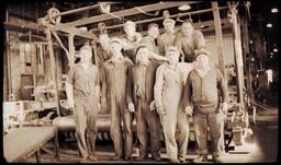 (010-002) Ten Men Standing in front of Machine