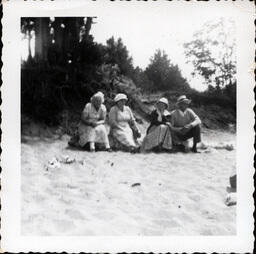 Four People on Beach Driftwood