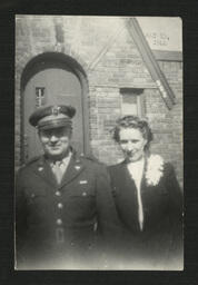 Man in Uniform and Woman with Corsage