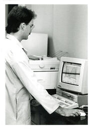 Man Looking at Wave Length Graph on Computer (Part of the NMU Historic Photographs Collection)