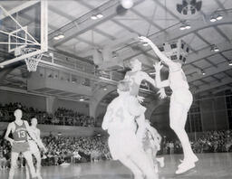 NMC Basketball--Aquinas Basketball 1960-61: Basketball Players By Net