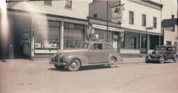 (004-007) Exterior Front View of Lakeside Garage and the White Eagle Hotel