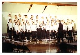 Choir Concert on Risers on Stage in Empty Room (Part of the NMU Historic Photographs Collection)