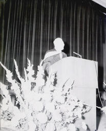 Commencement--Dr. Gunther Meyland Jan. 1961: Man Speaking on Stage at Commencement