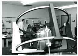 Professor and Student Working with Microscope in Physics Lab (Part of the NMU Historic Photographs Collection)