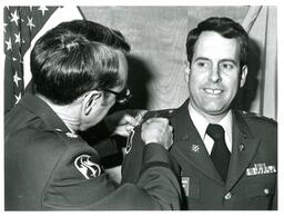 Man Pinning Medal onto Davis’ Shoulder (Part of the NMU Historic Photographs Collection)