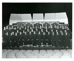 Portrait of Choir in Robes on Stage in Empty Auditorium (Part of the NMU Historic Photographs Collection)