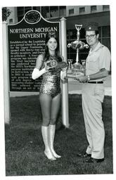 Woman in Leotard Receiving Trophy in front of University Center (Part of the NMU Historic Photographs Collection)