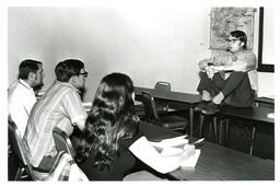 Professor Lecturing Students while Sitting on Desk (Part of the NMU Historic Photographs Collection)