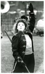 Closeup of Color Guard Member Raising Hand on Football Field (Part of the NMU Historic Photographs Collection)