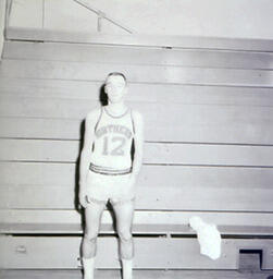 NMC Basketball--Individual Pictures 1960-61: Basketball Player No. 12 Posing for Photo