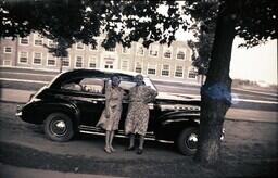 (007-016) Two Women Posing in front of Car